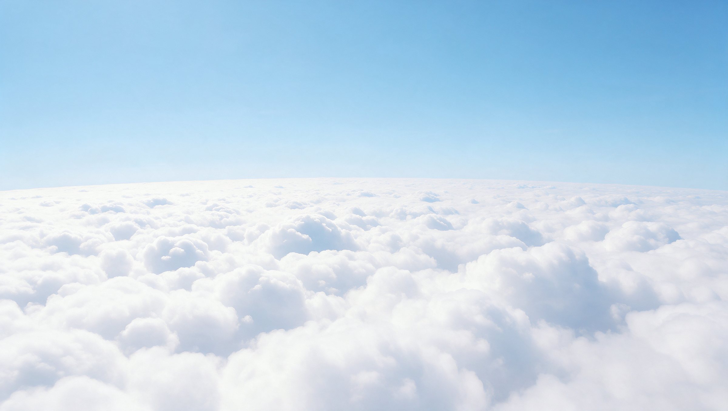A sea of white clouds under a pale blue sky